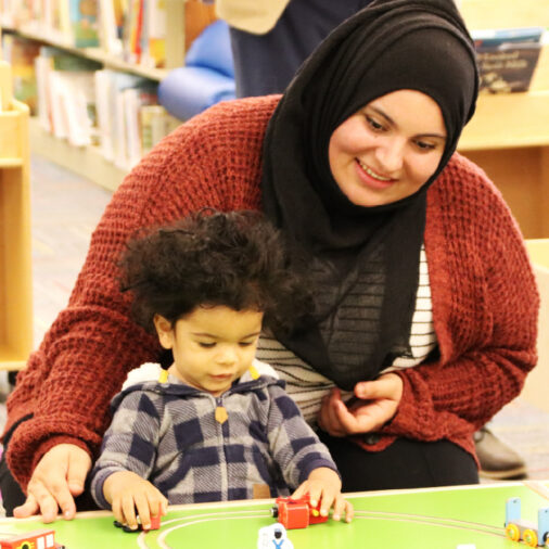 Adult helping child play and learn