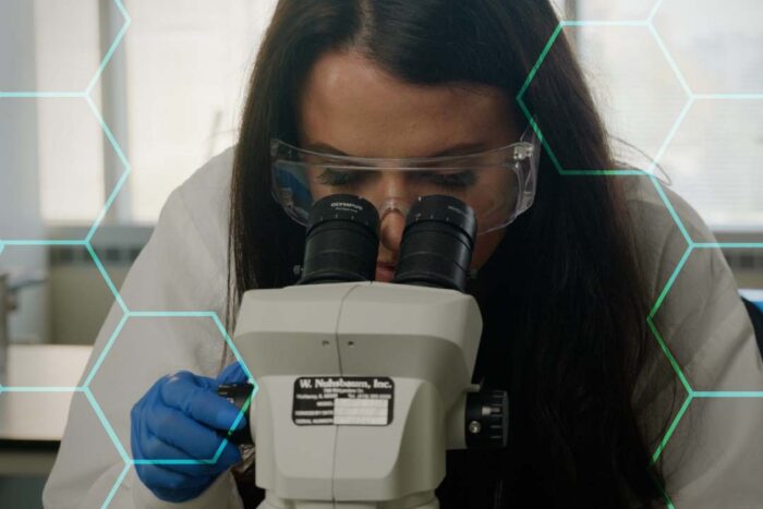 Scientist looking through microscope