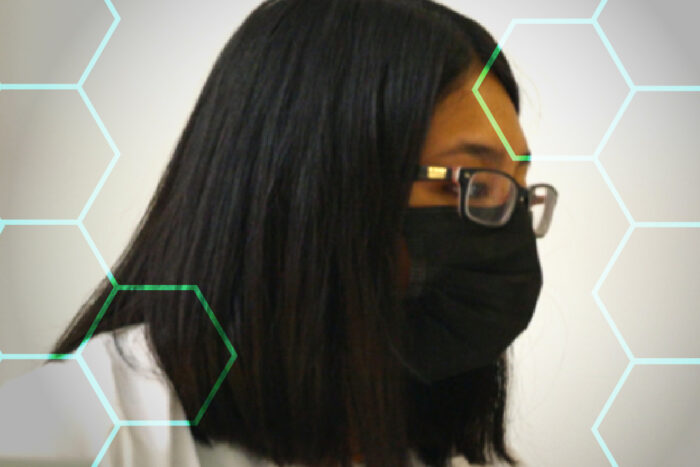 Scientist working in lab wearing white lab coat