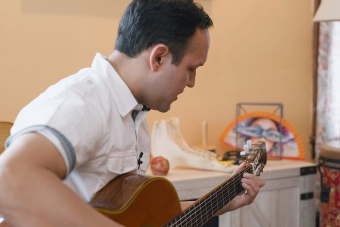 Richard Hildner Armacanqui, musical partner of Juan Tomás Martínez, with a guitar