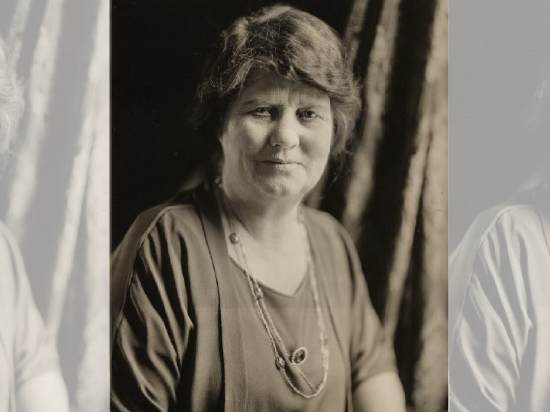 A black and white studio portrait of Belle Case La Follette as an older woman. She looks directly towards the viewer and her shoulders are angled to the right of the viewer.