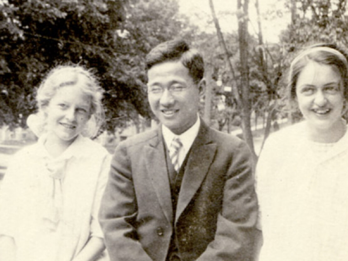 A black and white image of Mildred seated next to a young man and a young woman.