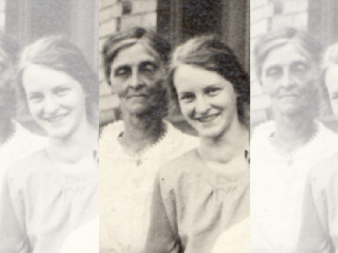 A black and white photo of a young Mildred standing next to her mother.
