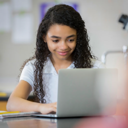 Young person using laptop computer in a lab